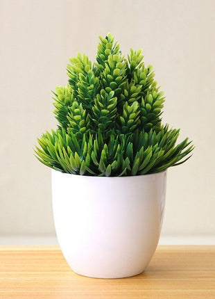 Plantas arbóreas pequeñas artificiales en macetas verdes